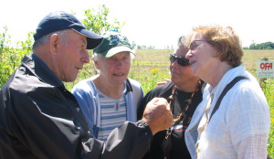 Keith Wood and his wife Ina  talk to Anishinaabekwe Patricia Watts and Maude Barlow of Council of Canadian. They were part of a happy crowd on Tiny Concession 2 on August 26 2009, the day after Simcoe County Council voted for a moratorium on the dump site. -AWARE Simcoe photo