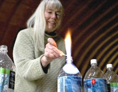 Jessica Ernst burns off some of the methane from a bottle of her well water from Rosebud, Alta., which she says was contaminated by hydraulic fracturing, also known as fracking. -CP photo