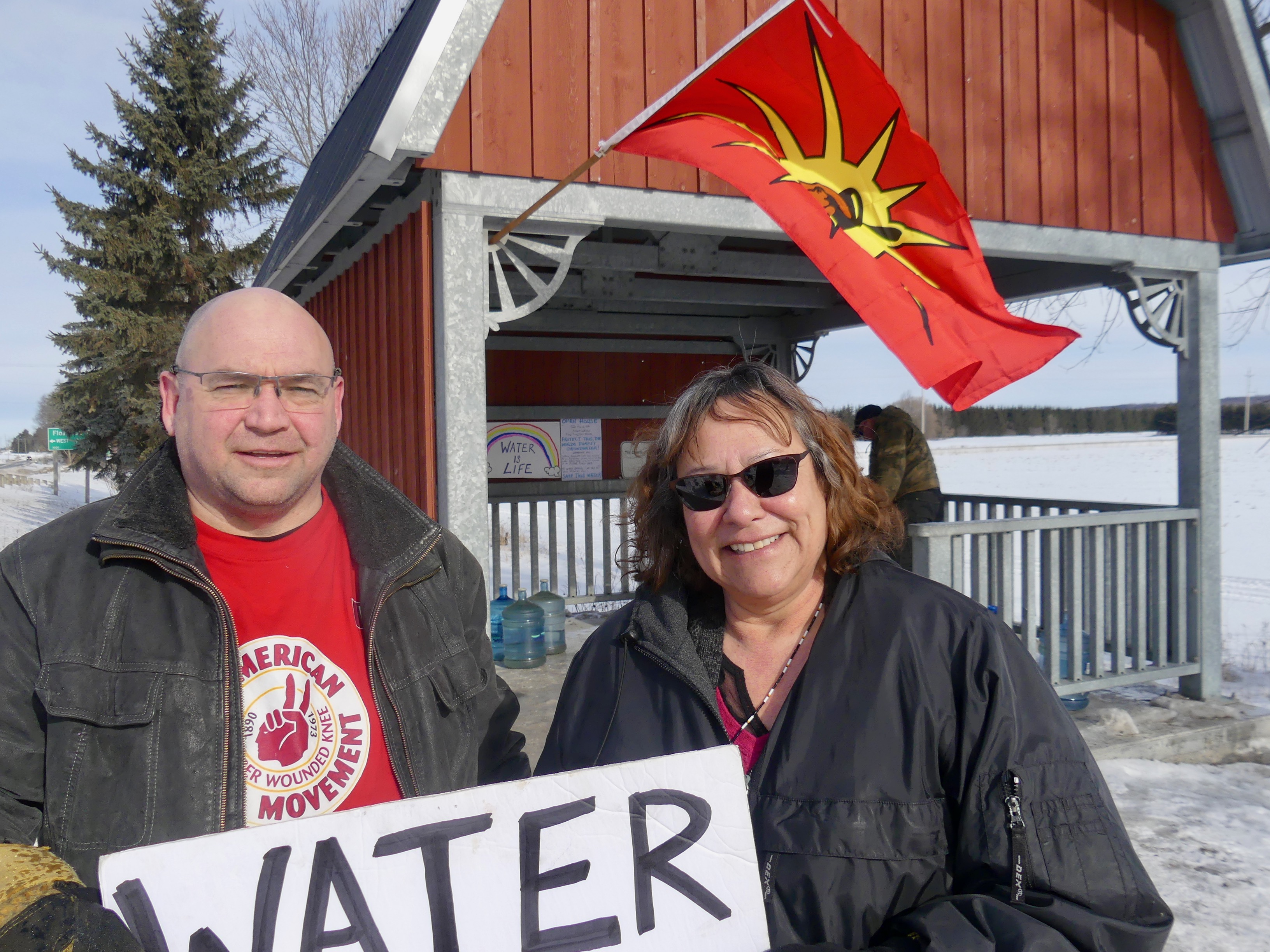Dave Stock and Beth Brass Elson after flag is raised at the Elmvale flow. -AWARE Simcoe photo